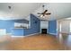 Open-concept living room with hardwood floors, fireplace, and seamless flow to the adjacent kitchen at 1529 Wellesley Cir, Mount Pleasant, SC 29466