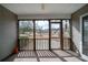 Cozy screened-in porch featuring a ceiling fan, a storm door, and a view of the home's backyard at 1529 Wellesley Cir, Mount Pleasant, SC 29466