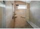 Walk-in shower featuring stone tiling, shower bench, and adjustable shower head at 1529 Wellesley Cir, Mount Pleasant, SC 29466