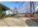 Expansive backyard featuring a deck, patio space, mature trees, and privacy fence, creating an outdoor retreat at 1656 Lauda Dr, Mount Pleasant, SC 29464