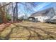 Spacious backyard featuring mature trees, a boat on a trailer, and a small deck with outdoor furniture at 1656 Lauda Dr, Mount Pleasant, SC 29464