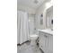 Bathroom with white vanity, toilet, and shower-tub combo, accented with light fixtures and framed art at 1656 Lauda Dr, Mount Pleasant, SC 29464