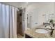 Bathroom with granite countertops, dual sinks, tiled shower with safety bars, and white shower curtains at 1656 Lauda Dr, Mount Pleasant, SC 29464