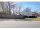 Exterior view of a well-maintained home featuring a fenced yard and mature trees, offering a private outdoor space at 1656 Lauda Dr, Mount Pleasant, SC 29464