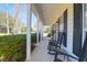 Inviting front porch with classic rocking chairs and white columns, enhancing curb appeal with views of mature trees at 1656 Lauda Dr, Mount Pleasant, SC 29464