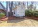 Charming backyard shed with double doors offers extra storage with an outdoor light fixture and decorative flower box at 1656 Lauda Dr, Mount Pleasant, SC 29464