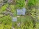 An aerial view of the property shows a home with a detached garage surrounded by mature trees and a green lawn at 1744 Pinckney Park Dr, Charleston, SC 29407
