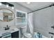 Bright bathroom featuring a white marble tiled shower, a round mirror, and modern fixtures at 1744 Pinckney Park Dr, Charleston, SC 29407