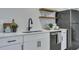 Modern kitchen featuring white cabinets, stainless steel appliances, quartz countertops, and stylish decor at 1744 Pinckney Park Dr, Charleston, SC 29407