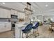 Stylish kitchen island with modern lighting fixtures and seating for casual dining at 1744 Pinckney Park Dr, Charleston, SC 29407