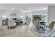 Open-concept living room featuring neutral walls, light wood floors, modern furniture, and a charming fireplace at 1744 Pinckney Park Dr, Charleston, SC 29407