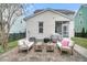 The backyard features a brick patio area, comfortable seating, and a screened-in porch for outdoor enjoyment at 1878 Carolina Bay Dr, Charleston, SC 29414