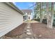 The backyard has a stone walkway leading to the house, mulched areas, and a black fence at 1878 Carolina Bay Dr, Charleston, SC 29414
