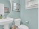 Cozy half bathroom with a pedestal sink, toilet, and neutral walls at 1878 Carolina Bay Dr, Charleston, SC 29414