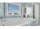 Beautiful bathroom with a soaking tub, shower and bright window with wooded views at 1878 Carolina Bay Dr, Charleston, SC 29414