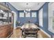 Stylish dining room with elegant lighting, blue walls, and a large wooden table at 1878 Carolina Bay Dr, Charleston, SC 29414
