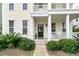 Inviting front porch with classic white railing and a cozy seating area at 1878 Carolina Bay Dr, Charleston, SC 29414