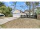 Detached garage with a white garage door and driveway, offering parking and storage at 1878 Carolina Bay Dr, Charleston, SC 29414