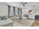 Open-concept living room with a sectional sofa and access to the kitchen and dining area at 1878 Carolina Bay Dr, Charleston, SC 29414