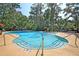 Community pool features a zero-entry access, splash fountain, and lounge chairs for relaxing at 1878 Carolina Bay Dr, Charleston, SC 29414