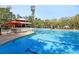 Resort-style pool with lounge chairs and seating area in a tropical setting with palm trees at 1878 Carolina Bay Dr, Charleston, SC 29414