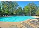 Large community pool with lounge chairs surrounded by lush greenery for relaxation and recreation at 1878 Carolina Bay Dr, Charleston, SC 29414