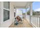 Covered porch with chair, blanket, side table and a view of the neighborhood at 1878 Carolina Bay Dr, Charleston, SC 29414