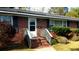 Inviting front porch with brick steps and white railing, leading to the front door at 1902 Morgan Ave, North Charleston, SC 29406