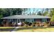 Charming brick home featuring a manicured lawn and mature landscaping at 1902 Morgan Ave, North Charleston, SC 29406