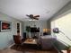 Bright living room with ceiling fan, large TV, neutral walls and wood flooring at 1902 Morgan Ave, North Charleston, SC 29406