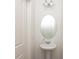 Powder room features a stylish pedestal sink, oval mirror, and sleek lighting fixtures at 192 Lyra Ln, Summerville, SC 29486