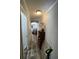 View of the hallway with wood floors, shelving unit, and view of the living room at 197 Melrose Pl, Moncks Corner, SC 29461