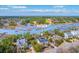 Aerial view shows waterfront home with dock, set among lush greenery and a golf course nearby at 2040 Ashburton Way, Mount Pleasant, SC 29466
