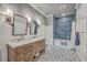 Stylish bathroom featuring a double vanity with a marble countertop, decorative tile flooring, and a tiled shower at 2040 Ashburton Way, Mount Pleasant, SC 29466