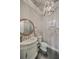 Charming powder room with a decorative mirror, sconces, and marble countertop at 2040 Ashburton Way, Mount Pleasant, SC 29466