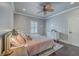 Cozy bedroom with a ceiling fan, a comfortable bed with soft pink bedding, and natural light at 2040 Ashburton Way, Mount Pleasant, SC 29466