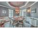 A stylish dining room featuring elegant wainscoting, decorative lighting and seating for six at 2040 Ashburton Way, Mount Pleasant, SC 29466