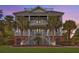 Elegant two-story home featuring a grand double staircase, a covered balcony and lush landscaping at 2040 Ashburton Way, Mount Pleasant, SC 29466