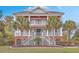 Beautiful two-story home with dual staircases, double porches, palm trees, and professionally landscaped yard at 2040 Ashburton Way, Mount Pleasant, SC 29466