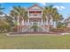Elegant two-story home featuring a grand double staircase, a covered balcony and lush landscaping at 2040 Ashburton Way, Mount Pleasant, SC 29466