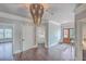 Bright foyer with hardwood floors, a decorative chandelier, and doorways leading to other rooms at 2040 Ashburton Way, Mount Pleasant, SC 29466