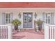Inviting front porch with double doors, lanterns, and stylish potted ferns, creating a warm welcome at 2040 Ashburton Way, Mount Pleasant, SC 29466