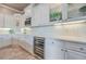 Modern kitchen featuring white cabinetry, marble countertops, and a built-in wine refrigerator at 2040 Ashburton Way, Mount Pleasant, SC 29466