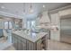 Open-concept kitchen with an island, stainless steel appliances, and elegant lighting at 2040 Ashburton Way, Mount Pleasant, SC 29466