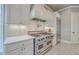 Updated kitchen featuring a stainless steel stove, hood, refrigerator, and tiled backsplash at 2040 Ashburton Way, Mount Pleasant, SC 29466