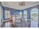 Luxurious bedroom with a four-poster bed, sitting area, and ample natural light at 2040 Ashburton Way, Mount Pleasant, SC 29466
