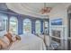 Bright bedroom featuring a fireplace, TV, and picturesque views from large windows at 2040 Ashburton Way, Mount Pleasant, SC 29466