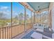Relaxing screened porch featuring a porch swing and comfortable seating, perfect for enjoying the peaceful scenery at 2040 Ashburton Way, Mount Pleasant, SC 29466