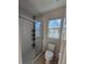 Cozy bathroom featuring a glass enclosed shower, toilet and tiled floors with natural light from window at 205 Grand Palm Ln, Summerville, SC 29485
