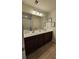 Bathroom with double sink vanity and ample counter space plus dark wood cabinets and large mirror at 205 Grand Palm Ln, Summerville, SC 29485